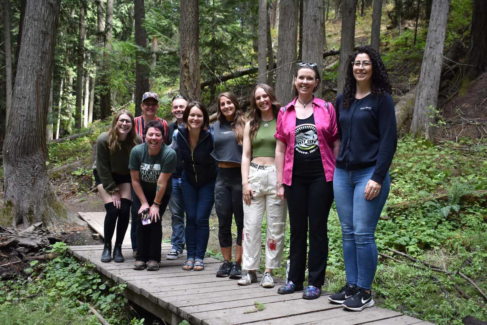 Group of Ambassadors for the Moscow Chamber standing on a small bridge in a forest