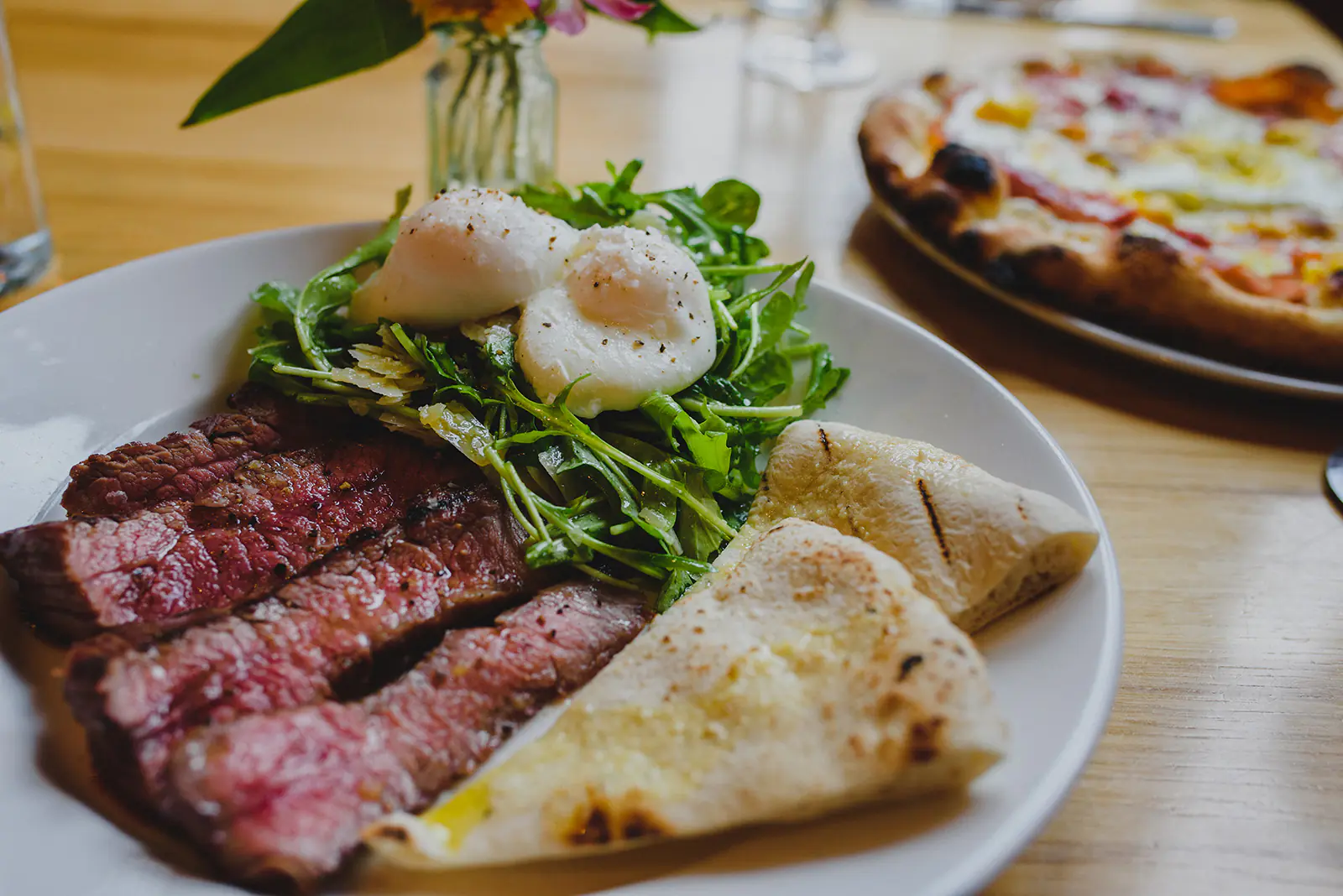 Close up of plate of steak, eggs, greens and pita bread at many of the restaurants in Moscow Idaho